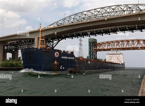 Freight ship passing under Burlington Canal Lift Bridge and Burlington ...