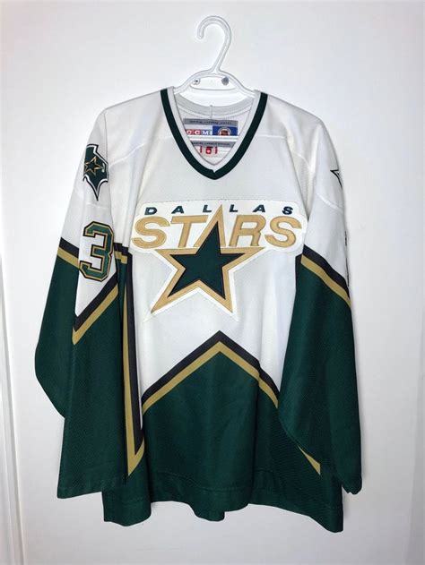 a hockey jersey hanging up on a door with the word, dallas stars ...