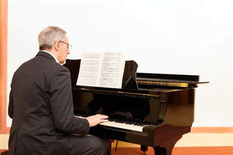 Old man playing piano — Stock Photo © Afonskaya #11824912