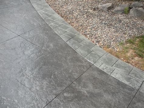 Black Stamped Concrete Driveway With Gray Borders