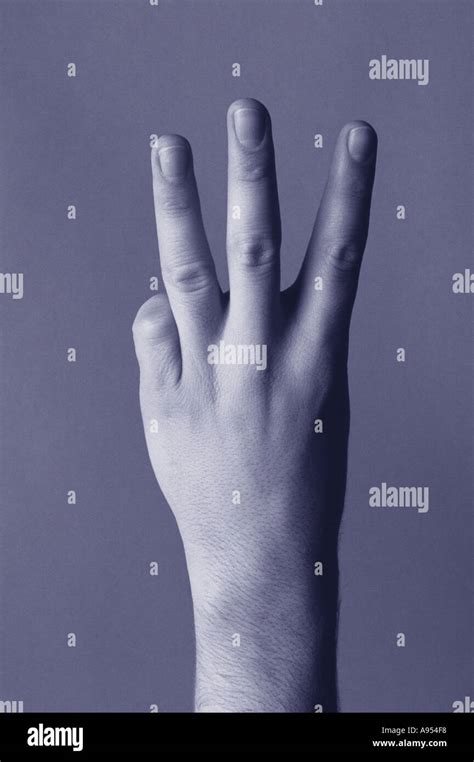 Hand showing three fingers Stock Photo - Alamy