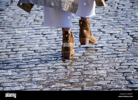 feet of a woman walking in boots Stock Photo - Alamy