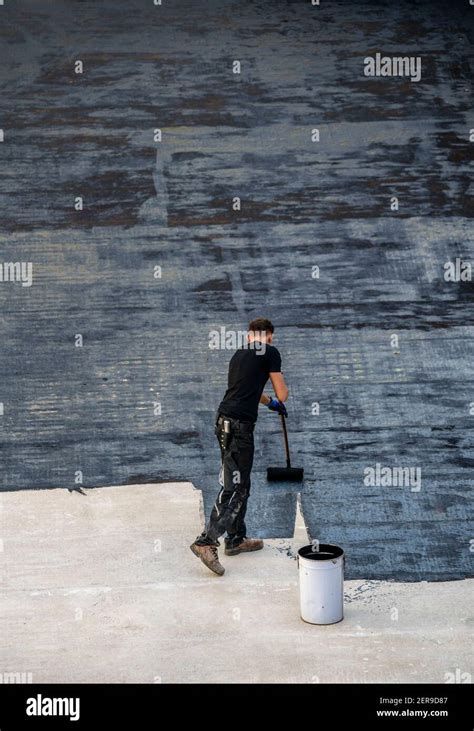 Construction site, application of a bituminous coating on a concrete ceiling, preparation for ...