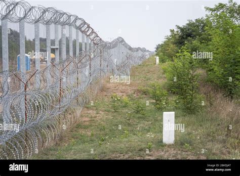 Border fence between Subotica (Serbia) & Kelebia (Hungary) with boundary marker. This border ...