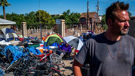 Hundreds of people in Phoenix homeless camp stuck outside during ...