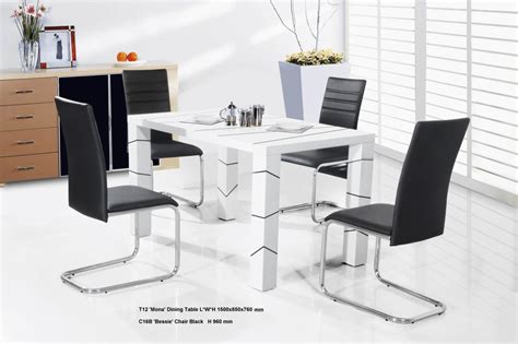 a white table with four black chairs around it