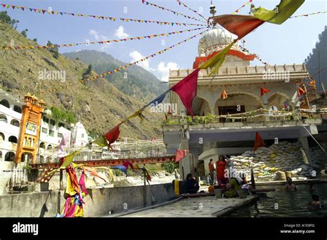 Manikaran hot springs pool public bath and flapping variegated flags ...