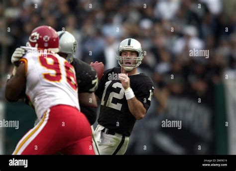 Oakland Raiders quarterback, Rich Gannon, looks for an open man in the ...