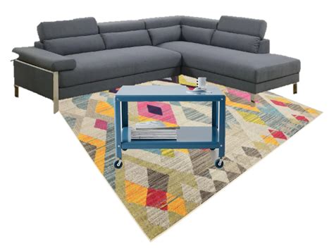 a large sectional couch sitting on top of a colorful rug next to a ...