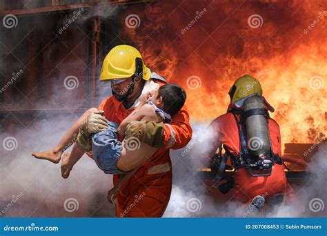 Firefighter Holding Child Boy To Save Him In Fire And Smoke Firemen ...