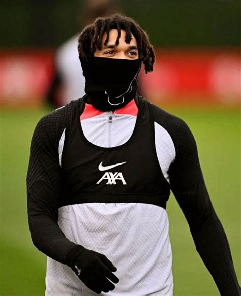 a man wearing a face mask on top of a soccer field