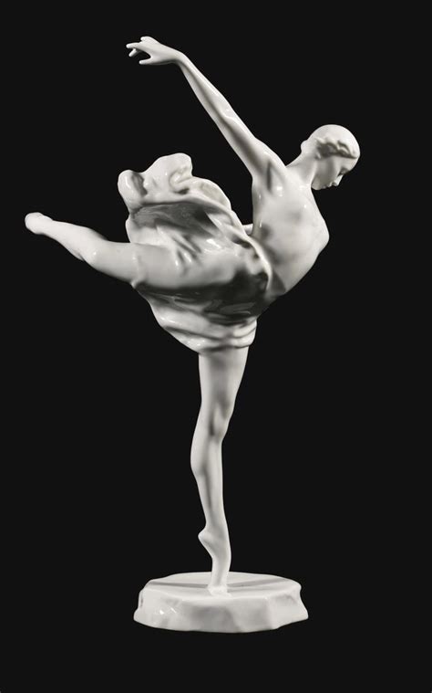 black and white photograph of a statue of a woman doing a dance pose with her arms outstretched