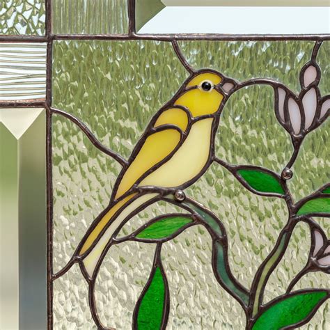 Stained glass canary birds sitting on the lemon tree panel