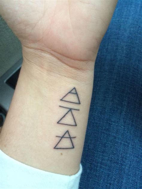 These three glyphs symbolize "Explore. Challenge. Transcend." They serve as a daily reminder for ...