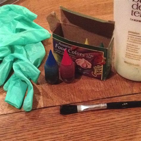 the contents of a crafting kit sitting on a table next to a bottle of glue