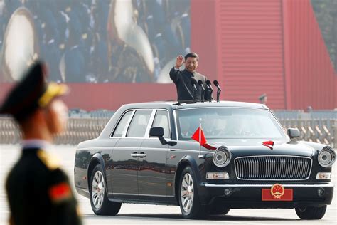 Chinese President Xi Jinping waves from a vehicle as he reviews the ...