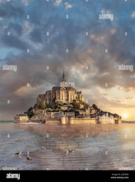 Scenic view of the tidal island of Mont Saint Michel at high tide surrounded and its medieval ...