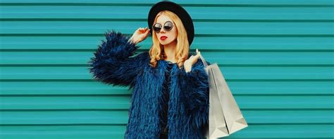 Fashionable Portrait Stylish Blonde Woman Posing with Shopping Bags Wearing a Blue Faux Fur Coat ...