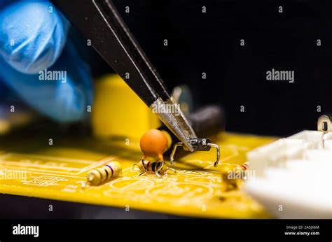 Technical support worker drops the fee PCB. Soldering iron. Tweezers Stock Photo - Alamy