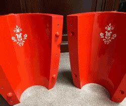 two red plastic vases sitting next to each other
