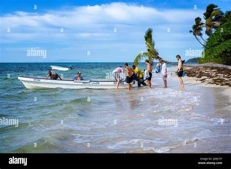 Group of tourists boarding small boat for a snorkeling trip, Nanuya Lai ...