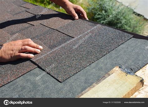 Asphalt Shingles Installation. Roofer Contractor Installing Asphalt Shingles on House Roofing ...