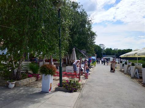 : People Relaxing on the Alleys with Restaurants of a Park Near Ada Ciganlija Lake , Serbia ...