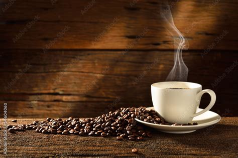 Coffee cup and coffee beans on old wooden background Stock Photo | Adobe Stock