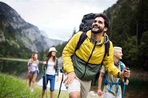 Group of young friends hiking in countryside. Multiracial happy people ...