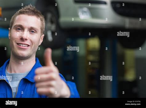 Smart car mechanic gesturing thumbs up Stock Photo - Alamy