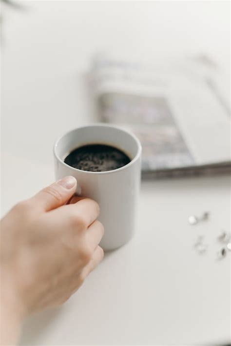 Person Holding White Ceramic Mug With Black Coffee · Free Stock Photo