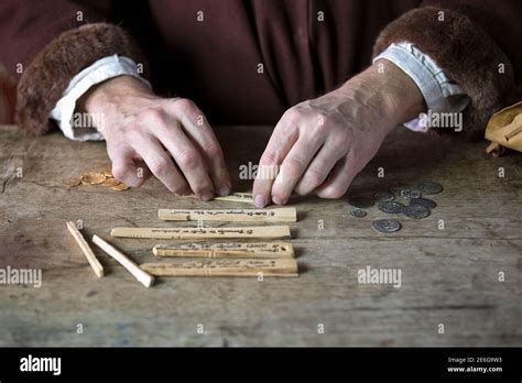 Medieval merchant counting money using tally sticks Stock Photo - Alamy