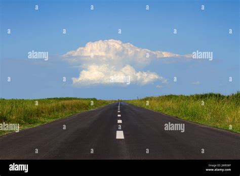 horizontal perspective view of black asphalt road with a large white ...