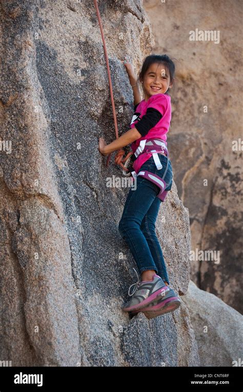 young girl rock climb climbing wall risk sport extreme outdoor nature ...