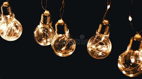Glowing Vintage Edison Light Bulbs Hanging on Ceiling on a Black Background Stock Video - Video ...