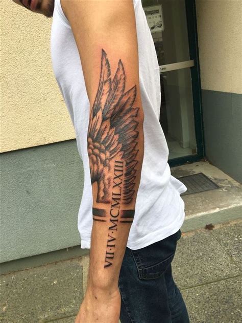 roman-numerals-arm-tattoo-fallen-angel-tattoo-angel-wing-man-with-white-top-jeans | Sleeve ...