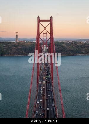 The 25 De Abril Bridge A Suspension Bridge Over The Tagus River In