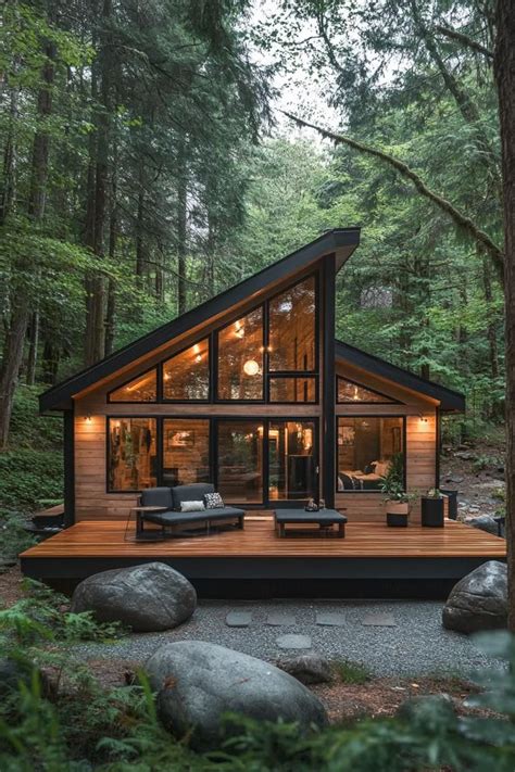 A Frame Cabin With Large Glass Windows In A Forest Setting Uncover How