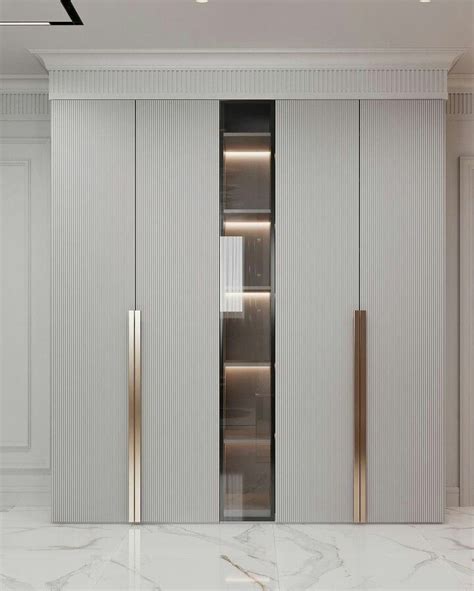 A White And Gold Closet In A Room With Marble Flooring Two Doors On