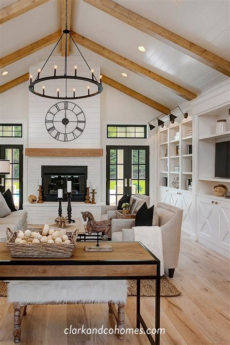 A Living Room Filled With Furniture And A Large Clock Mounted To The