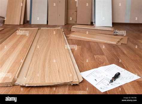 Wooden Planks Manual And A Screwdriver Laying On The Floor Stock Photo