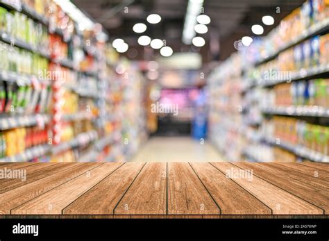 Empty top wooden table with supermarket blur background Stock Photo - Alamy