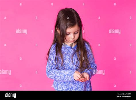 Pretty little girl on pink background Stock Photo - Alamy