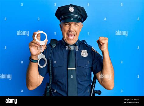 Handsome Middle Age Mature Man Wearing Police Uniform Holding Metal