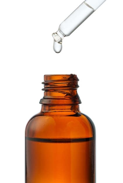 premium photo dropper bottle  liquid dropping   white background