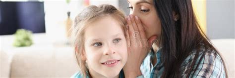 Mom Whispers Secret in the Little Girl Ear Stock Photo - Image of ...