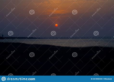 Beautiful Shot Of A Bright Blue Orange Sunset Sky Over A Seashore Stock