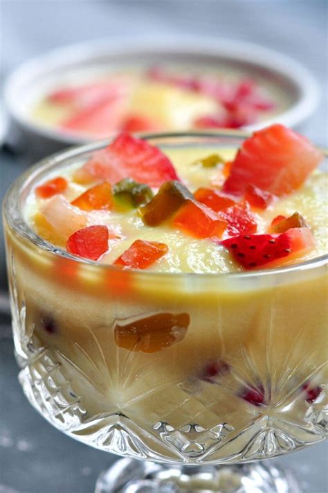 Two Dessert Dishes With Fruit In Them On A Table