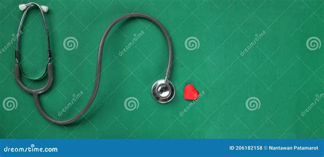 Image Of A Top View Stethoscope And Red Heart On A Green Background