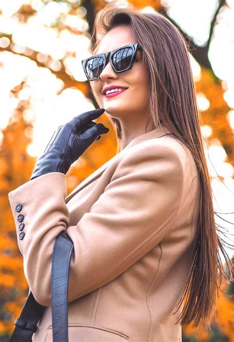 A Woman Wearing Black Gloves And Sunglasses